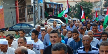 مسيرة في "برج الشمالي" احتجاجاً على تقليصات "الأونروا"